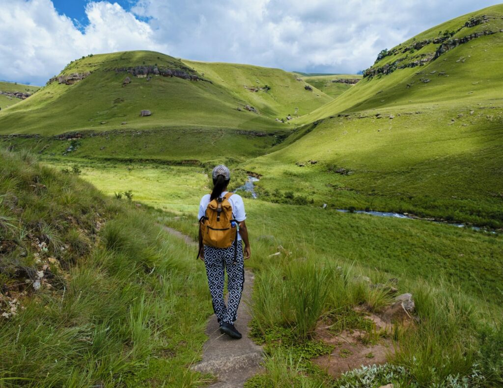 Young woman hiking in the mountains of Drakensberg South Africa